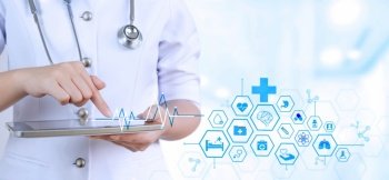 Female doctor or nurse using digital tablet with medical network interface icons on blurred hospital background, Modern medical technology concept