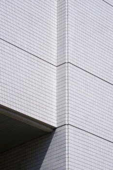Abstract geometric exterior architecture background of white tile wall of modern building in minimal style and vertical frame
