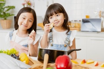 portrait healthy girl childs happy playing together in the kitchen eating apple fruit