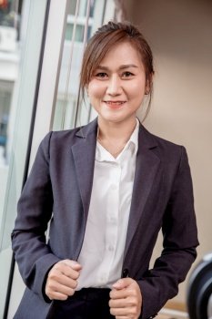 Business Southeast Asia Thai woman adult 40s standing confidence smiling with dressing suite vertical shot for company advertising.
