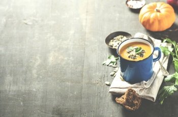 Pumpkin soup in a metal pot on a wooden surface with copy space. Pumpkin soup in a metal pot ???? ???? ?????