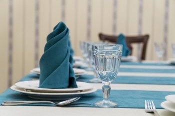 serving banquet table in a luxurious restaurant in turquoise and white style. served table in the restaurant