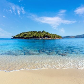 Beautiful Ionian Sea with clear turquoise water and morning summer coast view from beach (Ksamil, Albania).