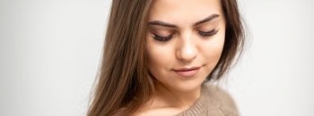 Portrait of beautiful young caucasian woman with closed eyes after eyelash extension procedure and permanent makeup. Woman with closed eyes after cosmetic procedure
