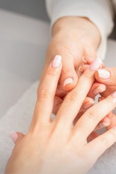 Manicure treatment at beauty spa. A hand of a woman getting a finger massage with oil in a nail salon. Manicure treatment at beauty spa. A hand of a woman getting a finger massage with oil in a nail salon.