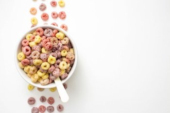 Healthy food concept, Colorful ring cereals in bowl and cereals arranged in row on white background.