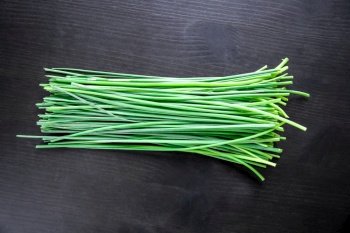 Bunch of fresh chives isolated on black background. Bunch of chives isolated on black