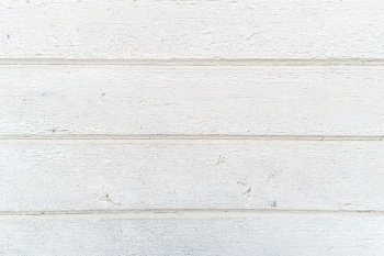 Background of old aged rough white painted wooden boards close up.