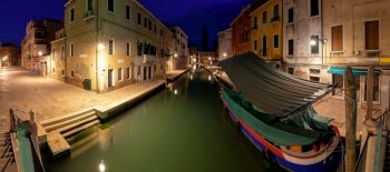 Facades of old traditional medieval houses along the canal at sunrise. Venice. Italy.. Old colorful houses over the canal in the early morning.