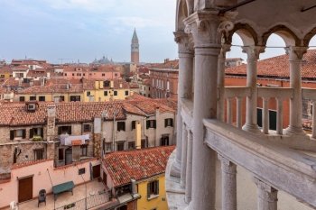View of the city from the top of the Scala Contarini del Bovolo spiral staircase. Venice. Italy.. Old medieval stone spiral staircase in Venice.