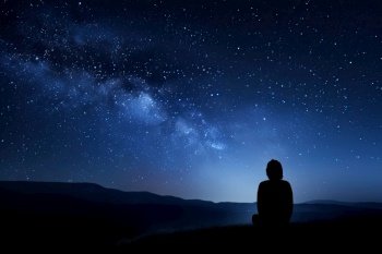 person, surrounded by dark blue backdrop, looking out at beautiful night sky with stars shining, created with generative ai