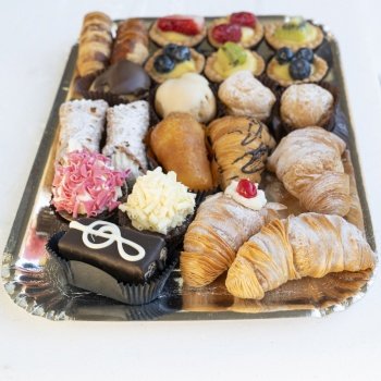 Top view of assortment of delicious and colorful pastries, made by pastry chef. All look tasty and delightful. Perfect for a party. Natural light