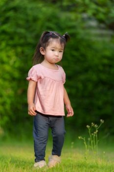 toddler girl in grass field