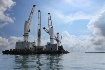 Marine cranes are used for loading and unloading cargo onto ships, The transportation and distribution center of Koh Sichang in Thailand.