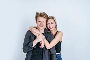 Portrait of happy young couple love together with flower in studio