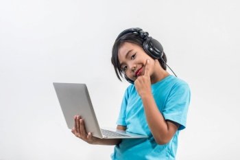 Little girl using laptop computer and listening lesson online 