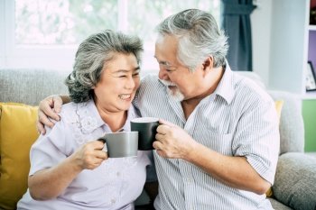 Elderly Couple Talking together and drinking coffee or milk