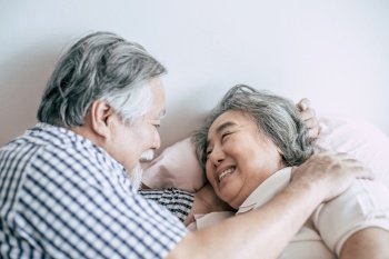 Senior couple lying in bed together