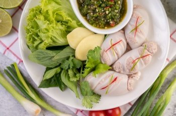 Squid stuffed with cooked pork with seafood sauce.