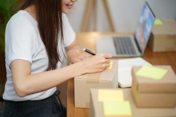 Asian woman preparing package delivery box Shipping for shopping online delivery mail service people and shipment concept.