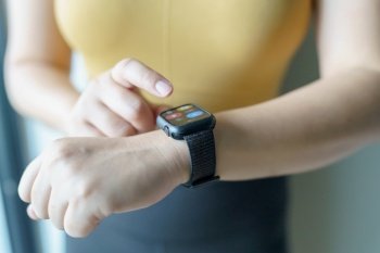 Woman workout with health app on smart watch Close-up hands.
