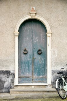 Old wooden door in the picturesque town of Levanto, Liguria Italy 