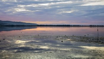 landscape of Orbetello Lagoon at sunset,  the most important lagoon of the Tiyrrhenian sea and natural reserve in the Grosseto province, Tuscany, Italy