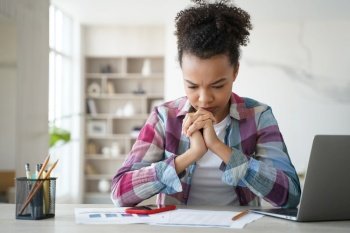 Schoolgirl has concentration problem. Overworked african american girl is studying remote at home. Teenage girl is sitting at workplace exhausted from homework. Distance learning on quarantine.. Schoolgirl has concentration problem. Overworked african american girl is studying remote at home.