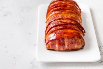 Bacon wrapped Meatloaf on the white plate