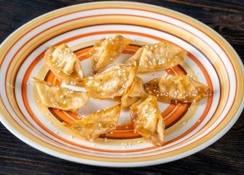 Portion of pan fried gyoza dumplings on the plate