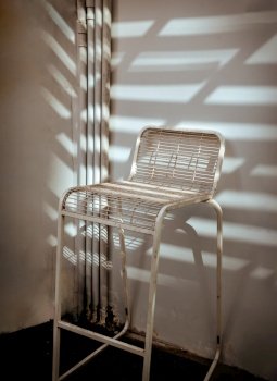 The stand alone chair is affected by Sunbeam shine through in the morning. Space for text, Selective focus.
