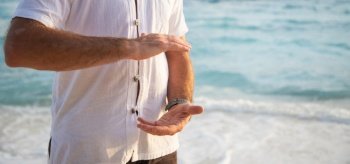 man practicing qigong by the sea