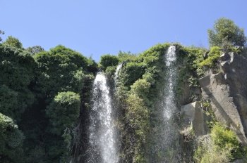 Jardin Extraordinaire, a garden in Nantes, France with a waterfall, rocks and lush vegetation.. Jardin Extraordinaire, a garden in Nantes