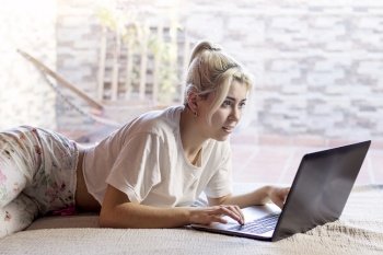 Serious and anxious woman watching at screen of computer, reading news or watching movie, online website surfing indoors at home. Getting information and feeling concerned or stressed.