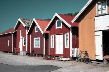 Colorful traditional fisherman huts, boathouses in row small harbor. Storage for fishing or rented as Holiday cottage summer. Colorful traditional fisherman huts, boathouses in row small harbor. Storage for fishing or rented as Holiday cottage