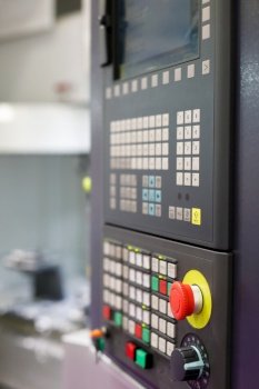 Closeup view of CNC machine control panel. Selective focus.
