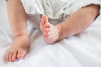 Small feet of a newborn baby. The concept of motherhood, breastfeeding. Small feet of a newborn baby. The concept of motherhood, breastfeeding.