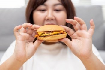 Overweight Woman Enjoy Eatting Beef Cheese Burger