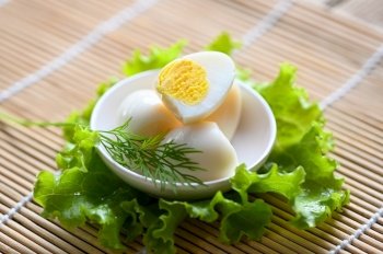 boiled eggs food, quail eggs on white bowl, breakfast eggs with fresh quail eggs and vegetable lettuce on table background