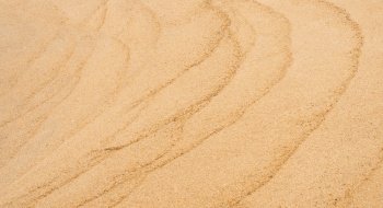 Sand texture backgrond.Top view Sandy beach,Natural sand stone texture with wave,Seaside view of Brown Beach sand dune in sunny day Spring,Wide Horizon for Summer banner backdrop background