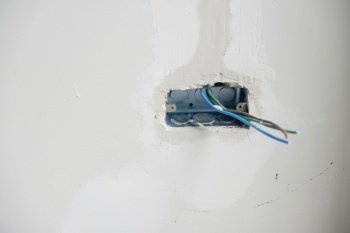 Electrical Wiring under plaster, hidden installation cables for socket to a concrete. Renovation, Repair and development of home and apartment concepts