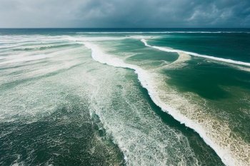 Spectacular aerial top view background photo of ocean sea water white wave splashing in the deep sea. Drone photo backdrop of sea wave in bird eye waves.. Spectacular aerial top view background photo of ocean sea water splashing.