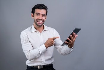 Confident businessman in formal suit holding tablet with surprise look for promotion or advertising. Facial expression and gestures indicate excitement and amazement on an isolated background. Fervent. Confident businessman in formal suit holding tablet with surprise look. Fervent