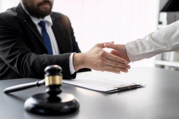 Closeup lawyer or attorneys colleagues handshake after successful legal discussing on contract agreement for lawsuit to advocate resolves dispute in court ensuring trustworthy partner. Equilibrium. Closeup lawyer colleagues or legal team handshake. Equilibrium
