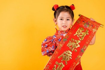 Chinese New Year. Happy Asian Chinese little child girl smile wearing red cheongsam qipao Spring festival couplets (Character 