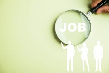 Innovative job search concept depicted by a magnifying glass highlighting JOB text, emphasizing use of technology, online resources, and networking to uncover rewarding career prospects. job search