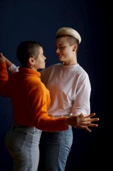 Happily smiling lesbian woman couple dancing playfully together feeling love and joy. Romance and homosexual relationship concept. Happily smiling lesbian woman couple dancing playfully together feeling love