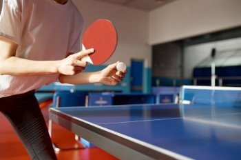 Closeup view of adult woman playing table tennis in gym. Training class at ping pong gaming club. Closeup view of adult woman playing table tennis in gym