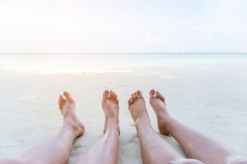 Couple relaxing in summer holiday on beach