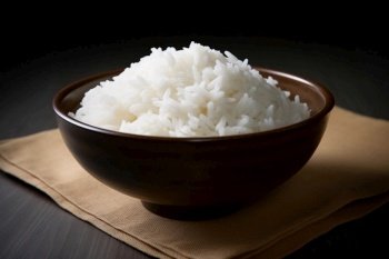 Bowl of rice on a brown and wooden background